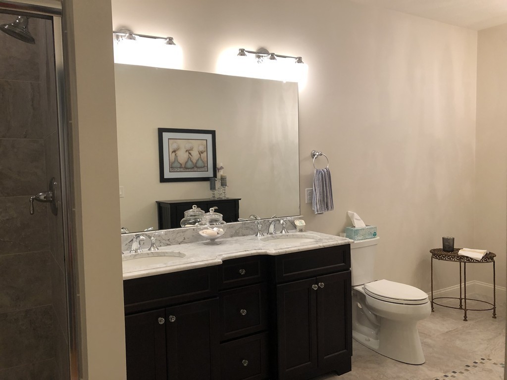 6 Adams Farm Road, Unit 6 Shrewsbury, MA 01545 - Photo 23 of 38 a bathroom with a granite countertop toilet sink and mirror