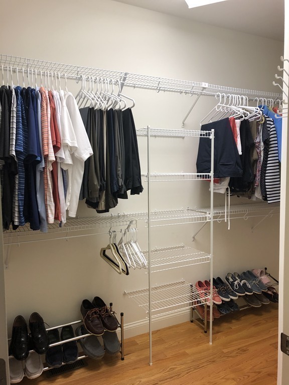 6 Adams Farm Road, Unit 6 Shrewsbury, MA 01545 - Photo 27 of 38 a view of walk in closet with clothes and shoes