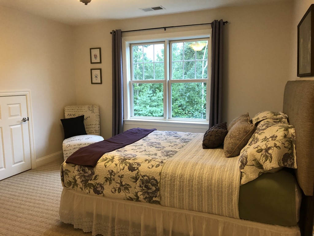 6 Adams Farm Road, Unit 6 Shrewsbury, MA 01545 - Photo 29 of 38 a bedroom with a bed and wooden floor