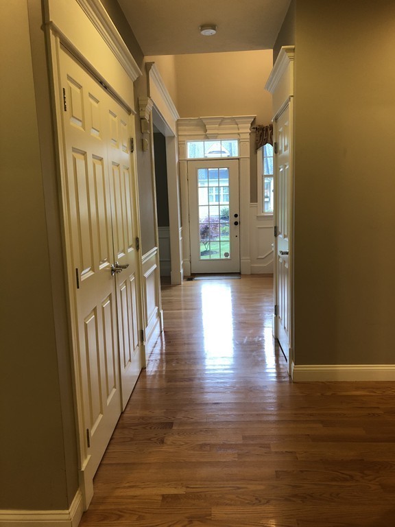 6 Adams Farm Road, Unit 6 Shrewsbury, MA 01545 - Photo 10 of 38 a view of a hallway with wooden floor and stairs