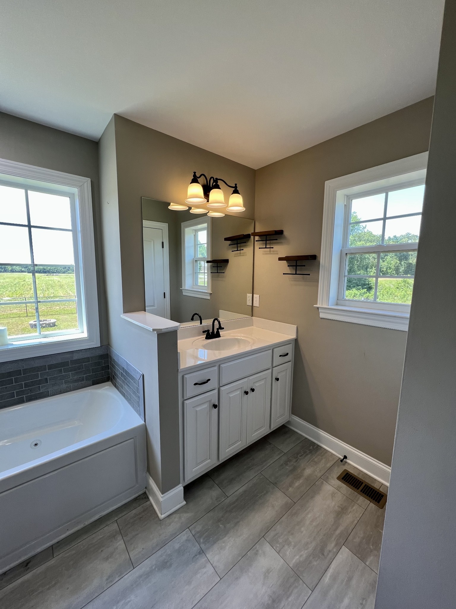418 Taylor Road Manchester, TN 37355 - Photo 19 of 30 a spacious bathroom with 2 sink tub and a mirror