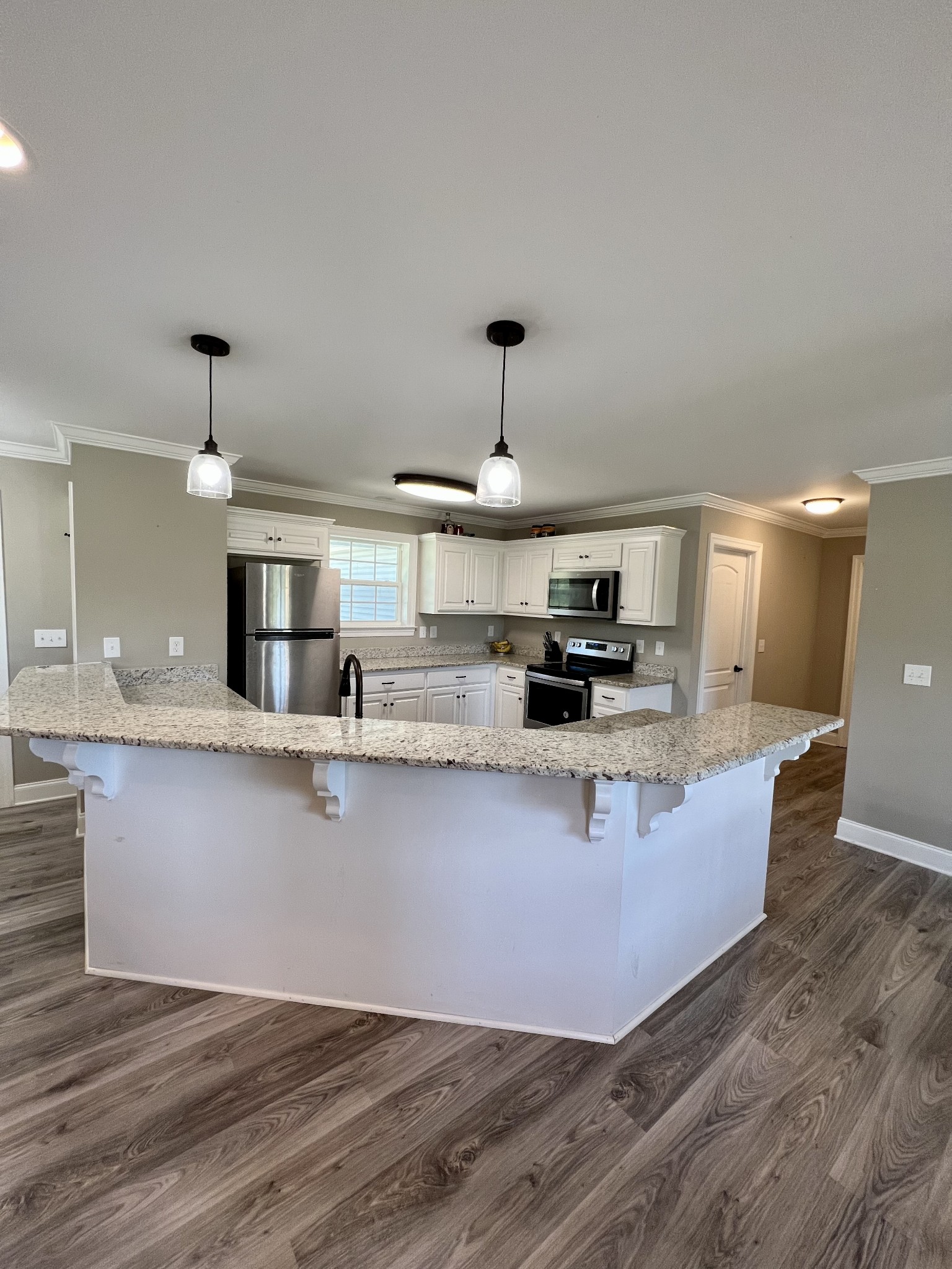 418 Taylor Road Manchester, TN 37355 - Photo 7 of 30 a kitchen with stainless steel appliances granite countertop a sink a stove and a wooden floors