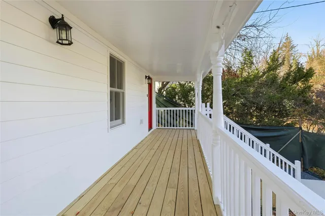 a view of balcony with wooden floor