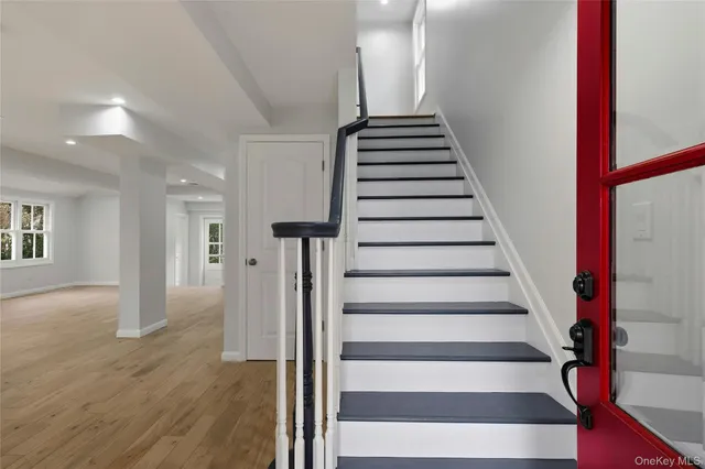 a view of entryway and hall with wooden floor