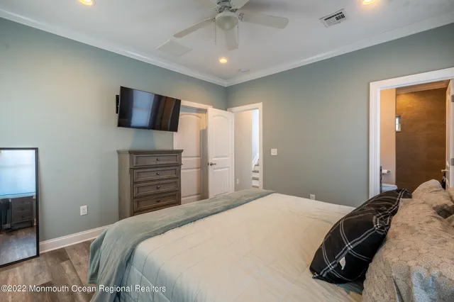 a bedroom with a bed and a television