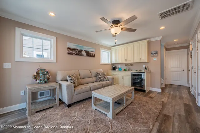 a living room with furniture and a view of kitchen