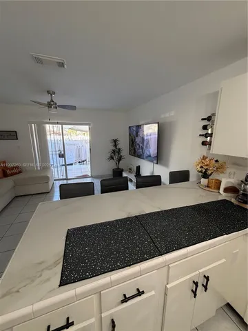 a bedroom with furniture and a large window