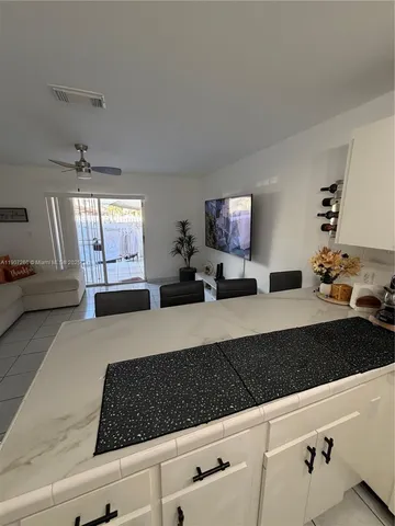 a bedroom with furniture and a large window