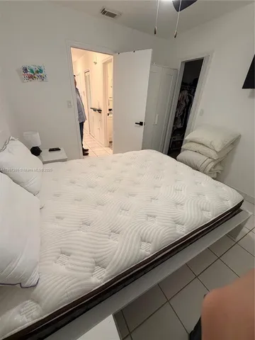 a large white bed in a white room