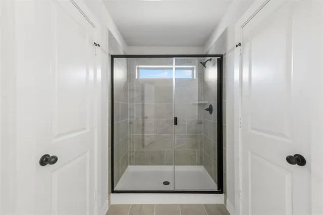 a bathroom with a glass shower door