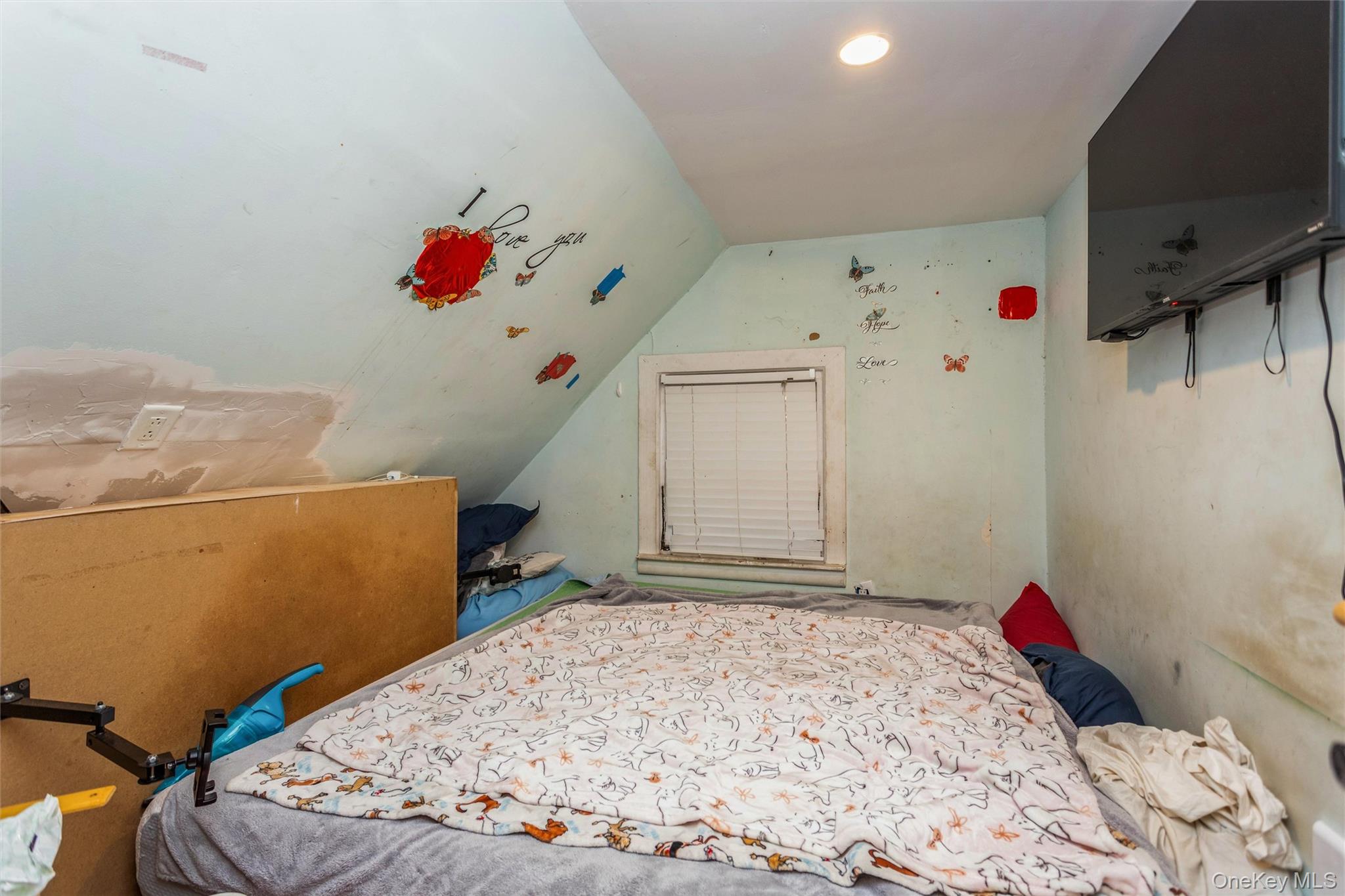 327 North 7th Avenue Mount Vernon, NY 10550 - Photo 15 of 32 a bedroom with a bed and a flat screen tv