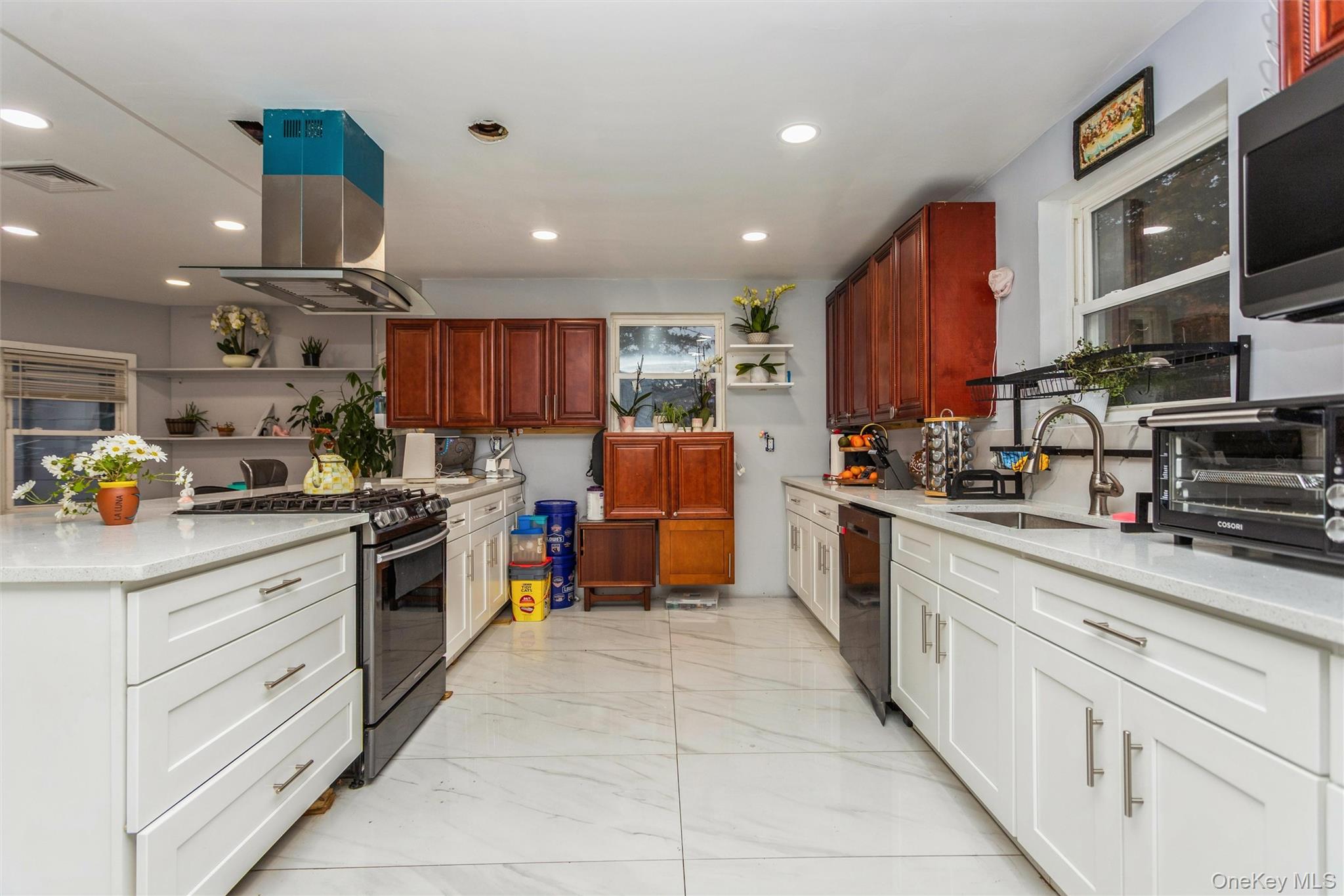 327 North 7th Avenue Mount Vernon, NY 10550 - Photo 7 of 32 a kitchen with stainless steel appliances granite countertop a sink counter space cabinets and a view of living room