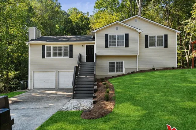 a front view of a house with a garden