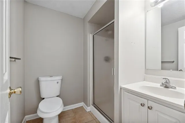 a bathroom with a toilet sink and a mirror