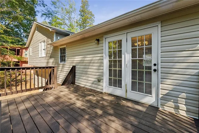 a view of a house with a big yard and large trees
