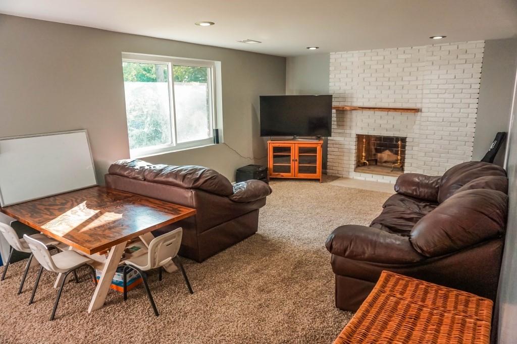 3211 Arapahoe Road Pittsburgh, PA 15241 - Photo 21 of 24 a living room with furniture a fireplace and a flat screen tv