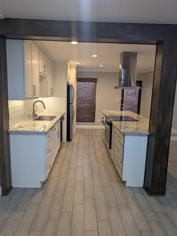 a spacious bathroom with a granite countertop sink