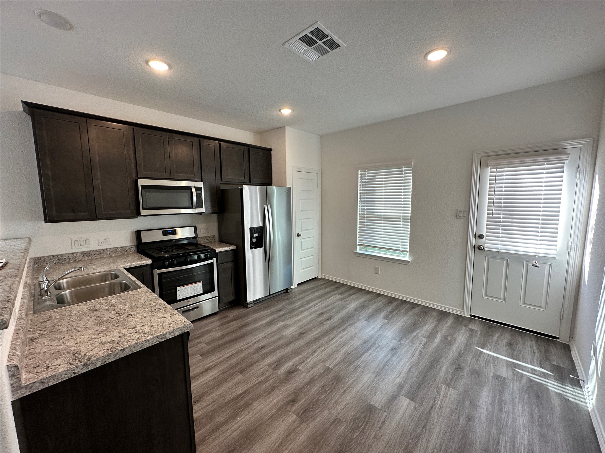 16504 Moss Lane Porter, TX 77365 - Photo 5 of 16 a kitchen with a refrigerator sink and microwave