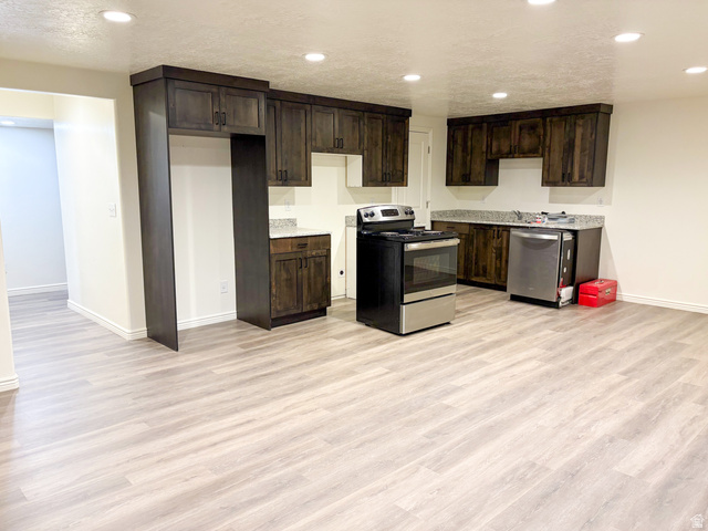 1666 West Foxberry Road Santaquin, UT 84655 - Photo 18 of 23 Kitchen with appliances with stainless steel finishes, dark brown cabinetry, recessed lighting, light wood-style flooring, and light countertops