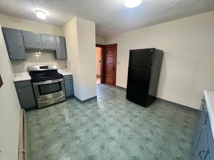 a kitchen with stainless steel appliances a refrigerator and a stove