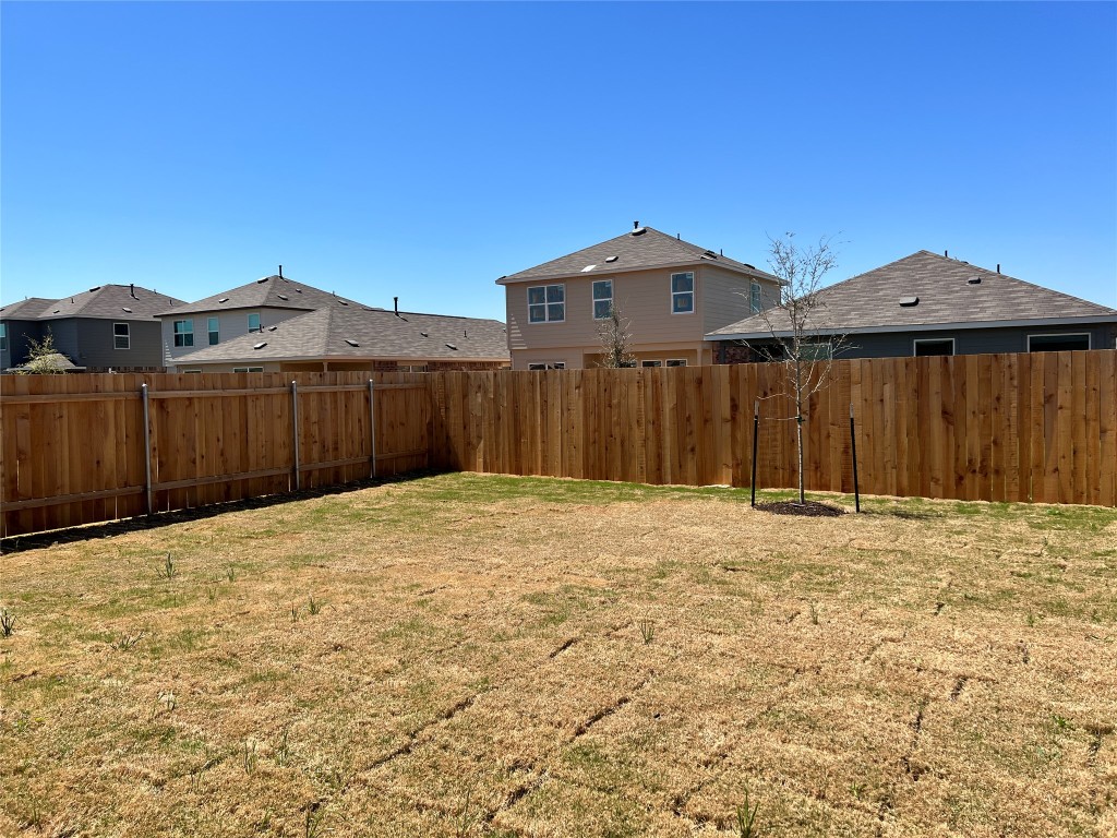 115 Canley Loop Hutto, TX 78634 - Photo 16 of 18 Fenced backyard with a residential view