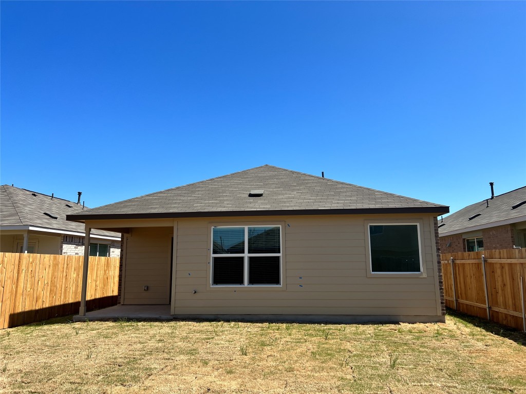 115 Canley Loop Hutto, TX 78634 - Photo 17 of 18 Rear view of house with a fenced backyard, a patio, and roof with shingles