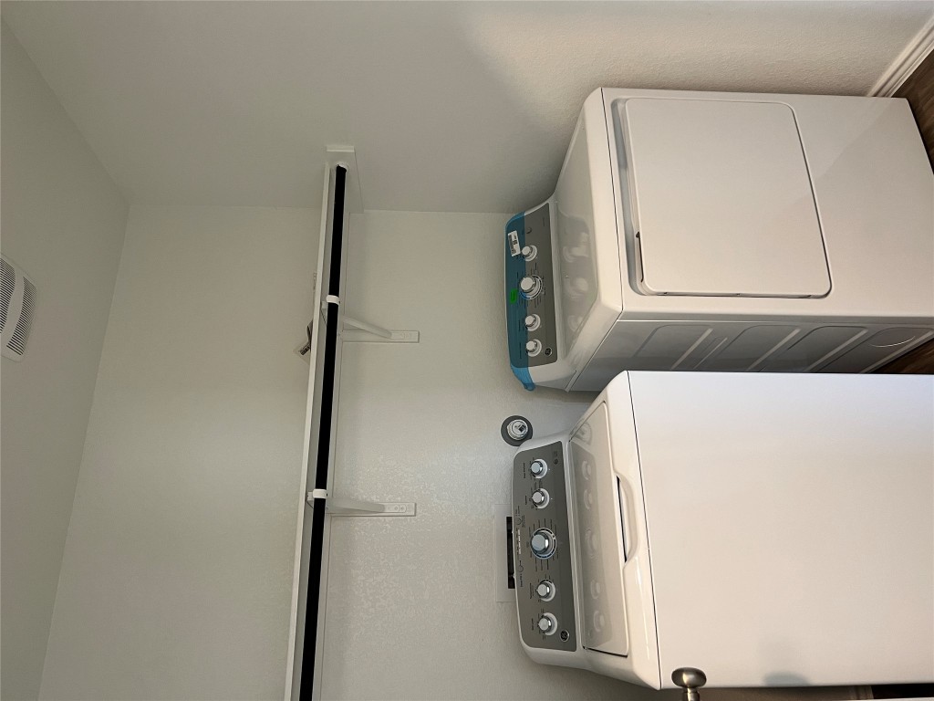 115 Canley Loop Hutto, TX 78634 - Photo 4 of 18 Laundry room with independent washer and dryer and dark wood-style floors