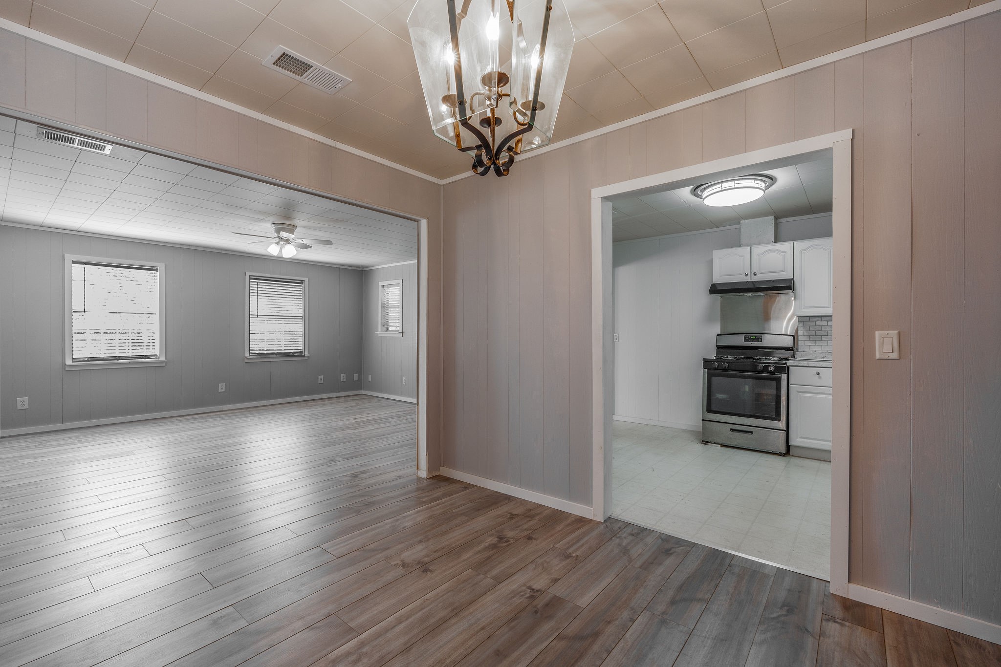 1310 Brazos Street Hempstead, TX 77445 - Photo 12 of 43 a view of a big room with wooden floor a kitchen space and windows