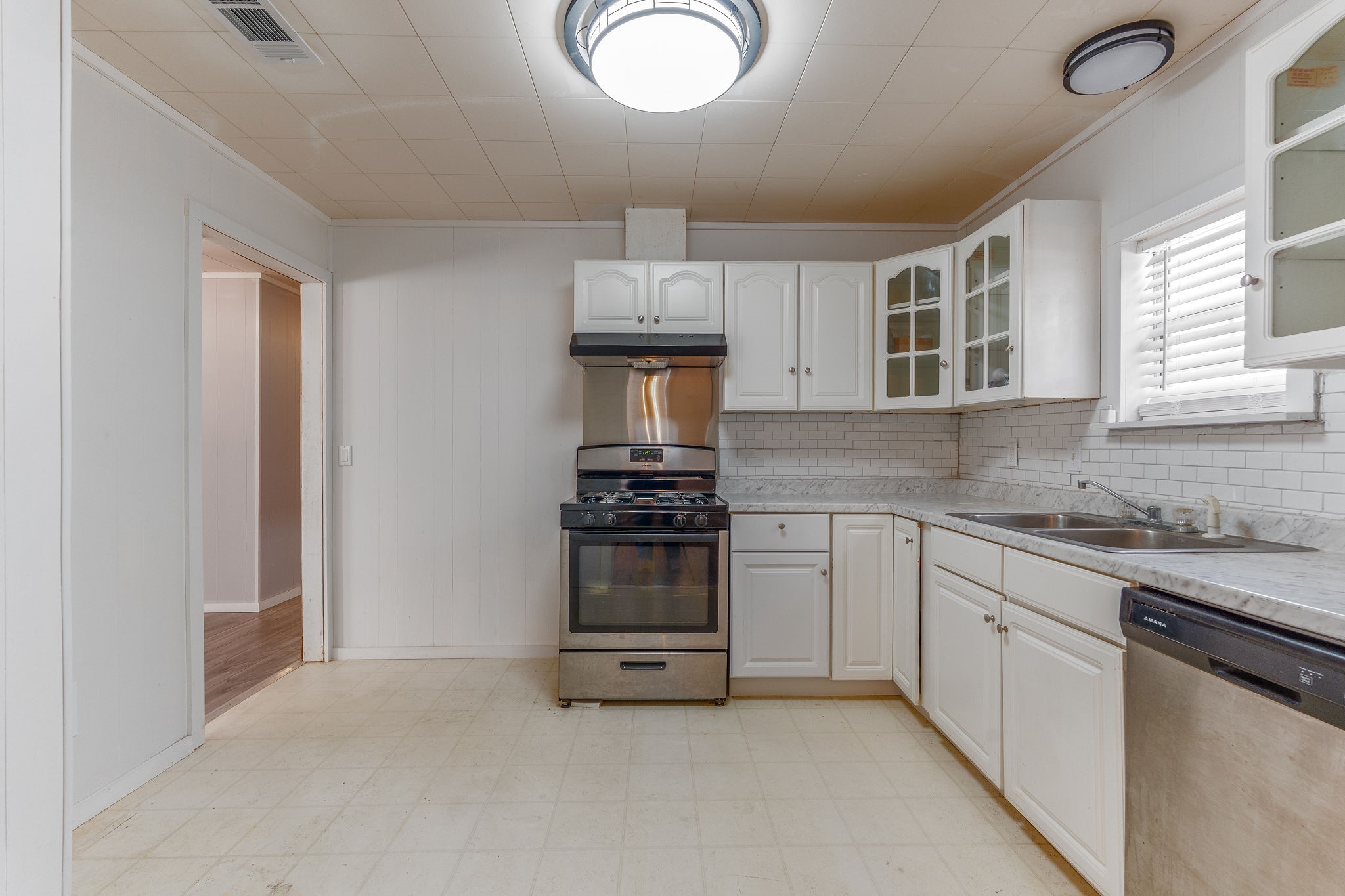 1310 Brazos Street Hempstead, TX 77445 - Photo 13 of 43 a kitchen with stainless steel appliances granite countertop a stove and a sink