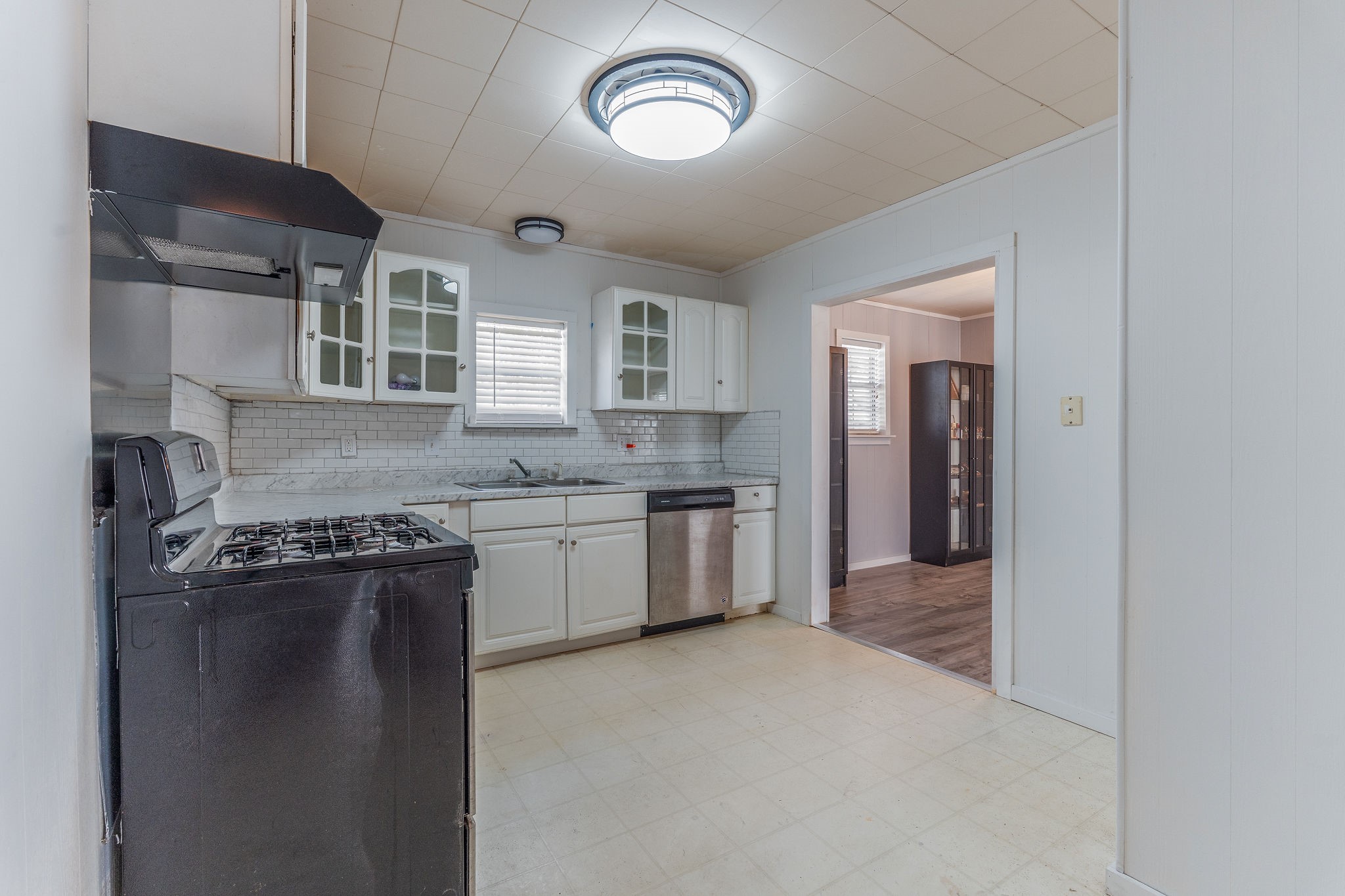 1310 Brazos Street Hempstead, TX 77445 - Photo 14 of 43 a kitchen with granite countertop a sink stove and refrigerator