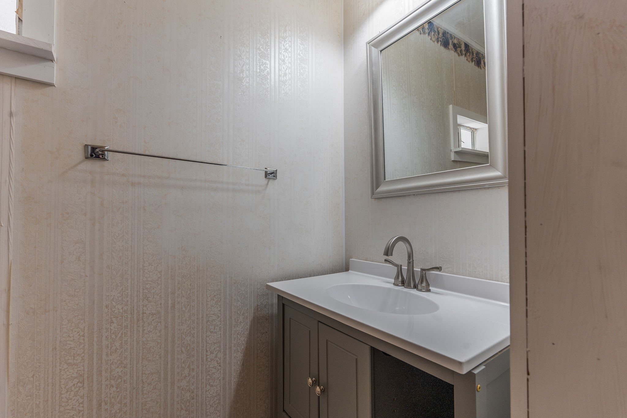 1310 Brazos Street Hempstead, TX 77445 - Photo 15 of 43 a bathroom with a sink and a mirror