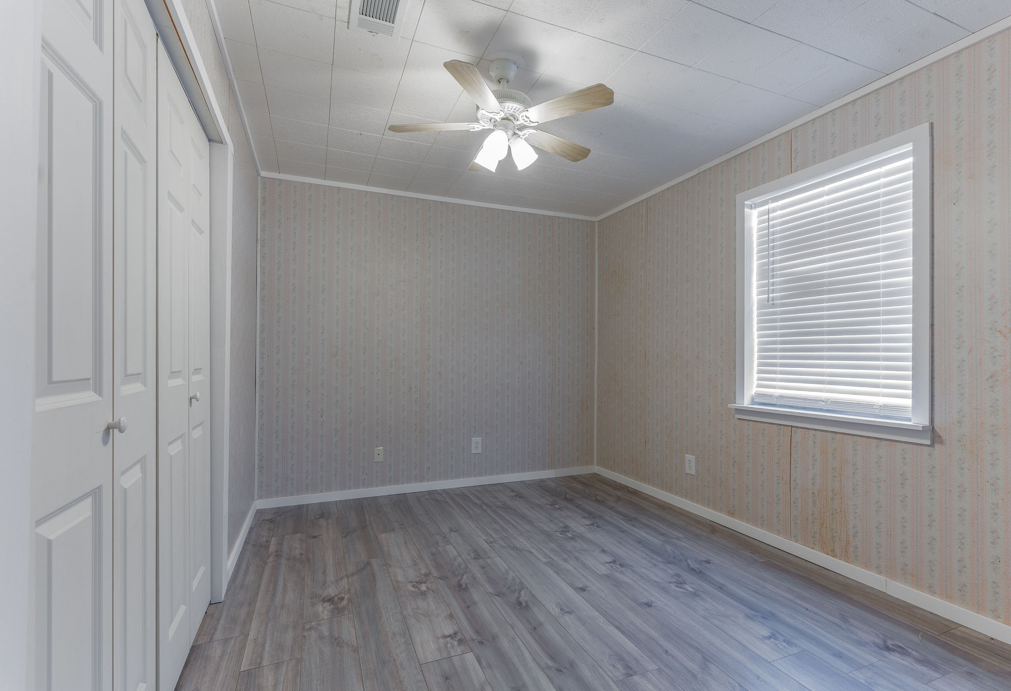 1310 Brazos Street Hempstead, TX 77445 - Photo 20 of 43 wooden floor in an empty room with a window