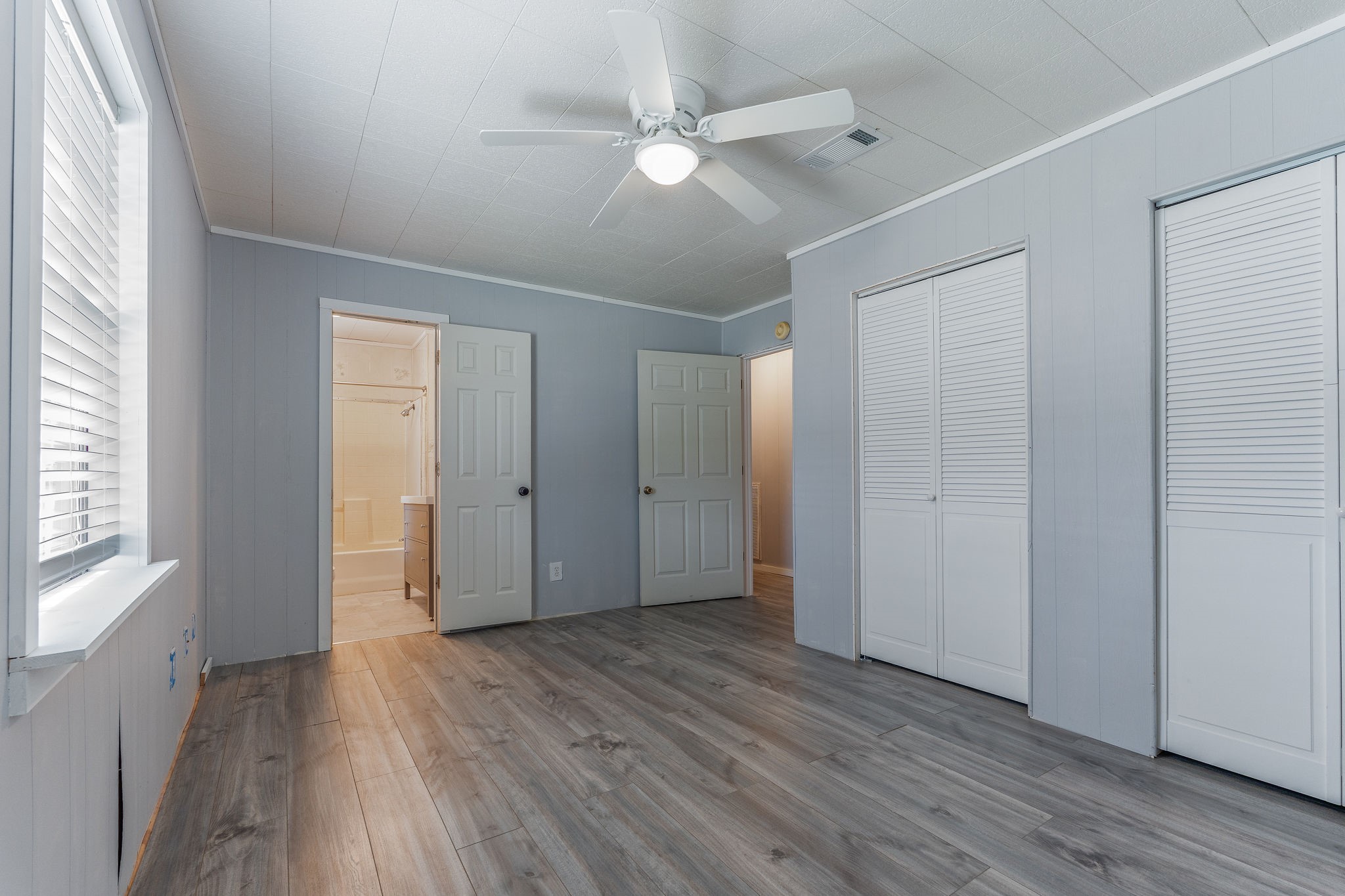 1310 Brazos Street Hempstead, TX 77445 - Photo 22 of 43 a view of an empty room with wooden floor and a window