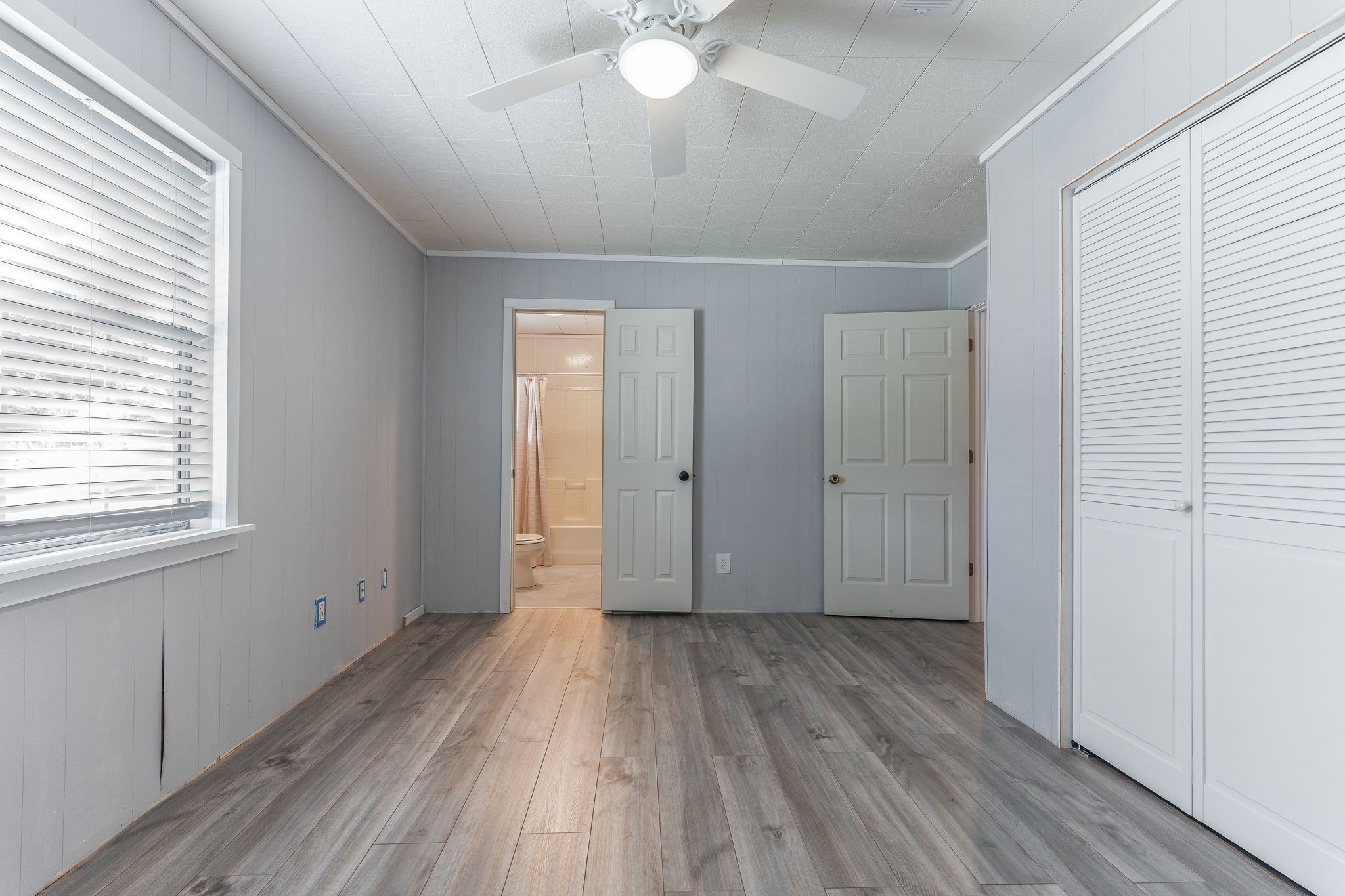 1310 Brazos Street Hempstead, TX 77445 - Photo 23 of 43 a view of empty room with wooden floor and fan