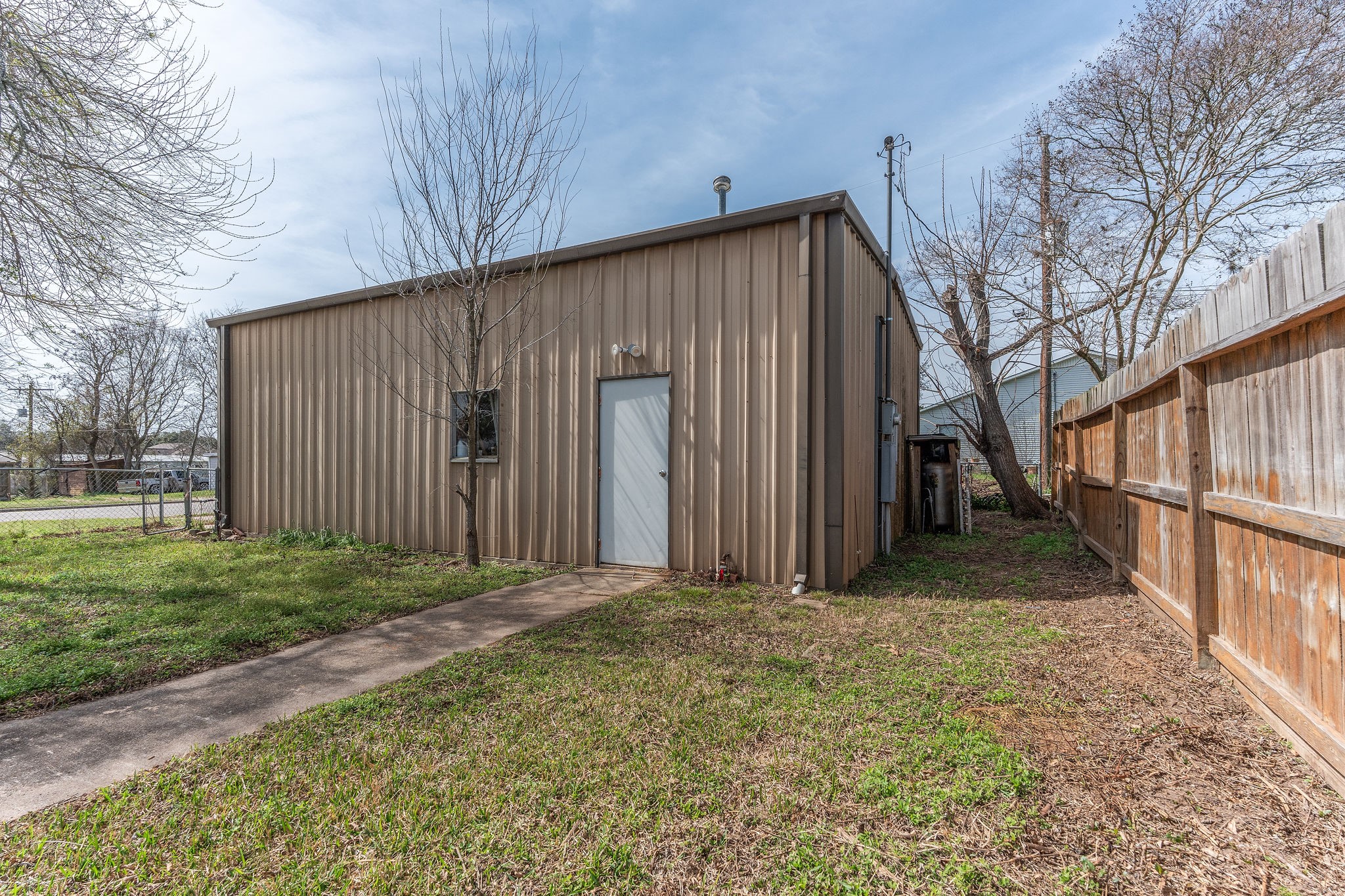 1310 Brazos Street Hempstead, TX 77445 - Photo 30 of 43 a view of a house with backyard and trees