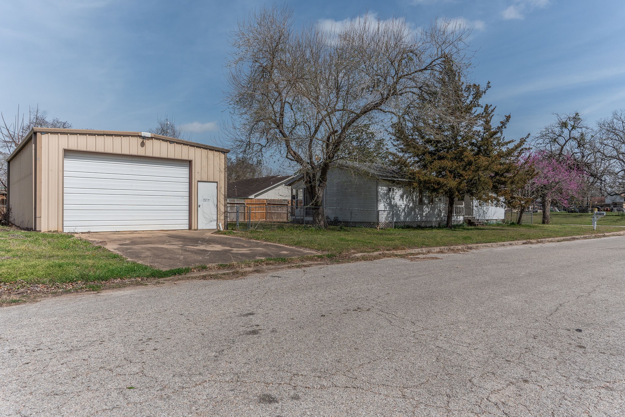 1310 Brazos Street Hempstead, TX 77445 - Photo 31 of 43 a view of a house with a yard and garage