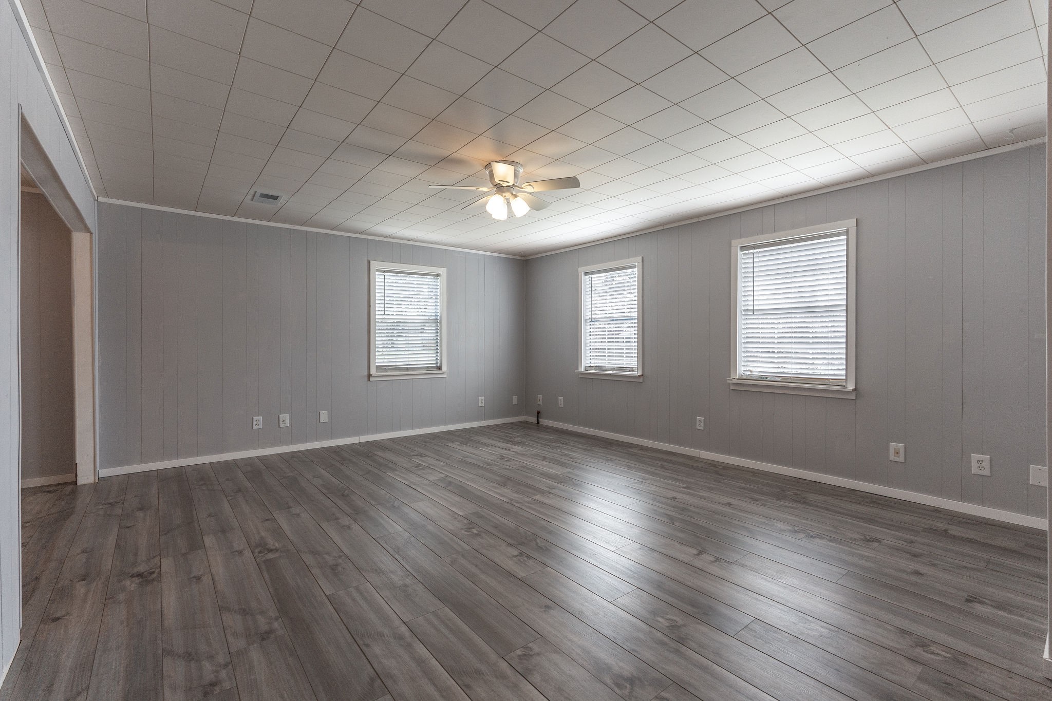 1310 Brazos Street Hempstead, TX 77445 - Photo 7 of 43 an empty room with wooden floor and windows