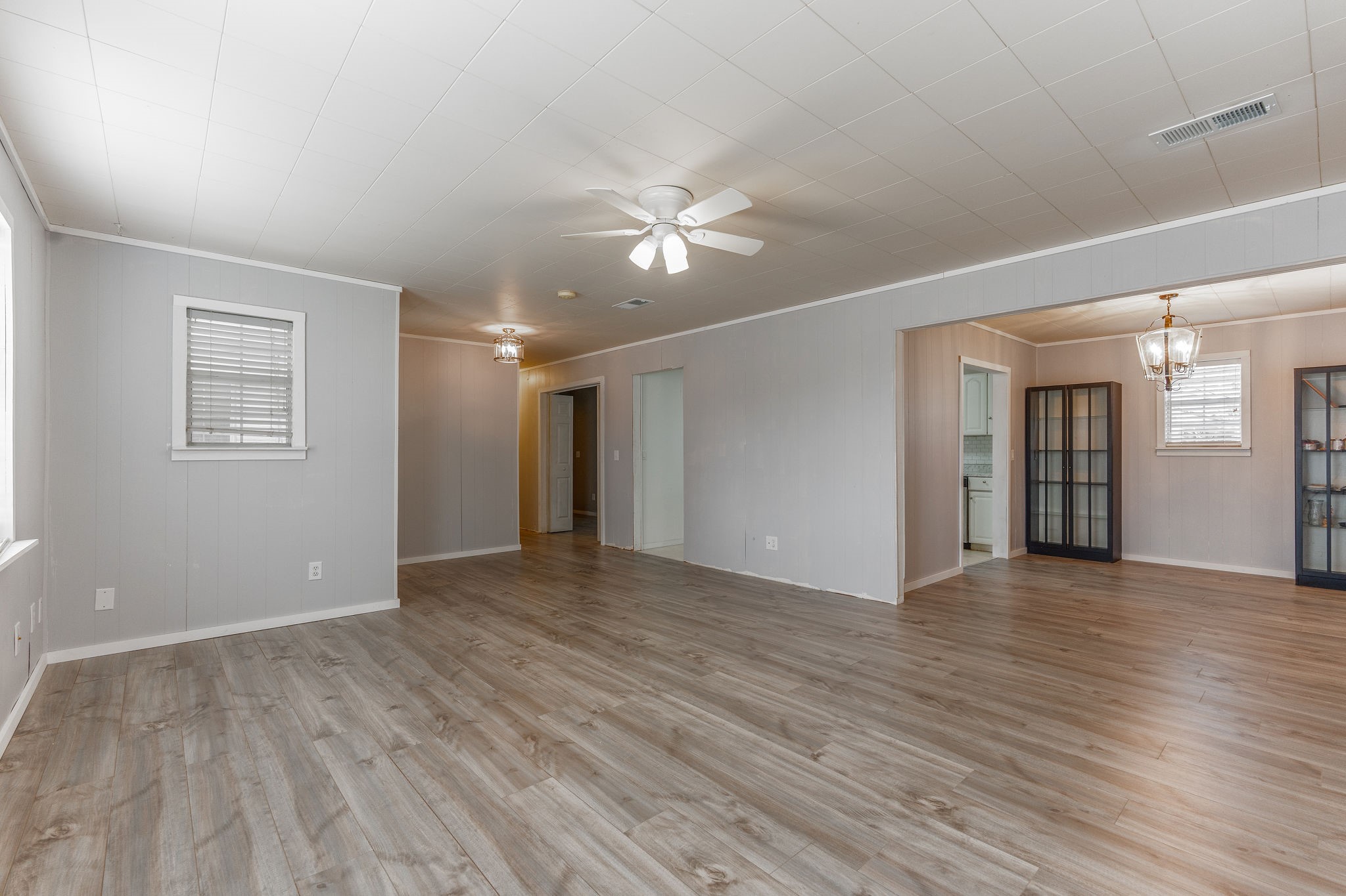 1310 Brazos Street Hempstead, TX 77445 - Photo 8 of 43 a view of an empty room with wooden floor and a ceiling fan