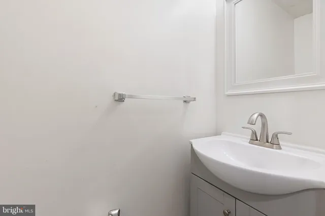 a bathroom with a sink and mirror