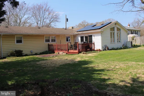 a view of a house with a yard and sitting area