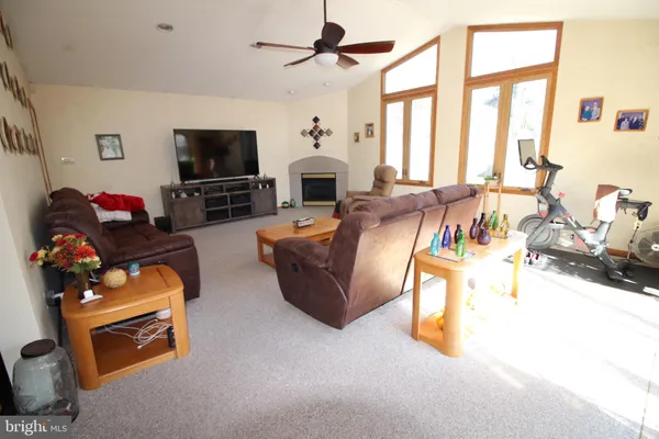 a living room with furniture a fireplace and a flat screen tv