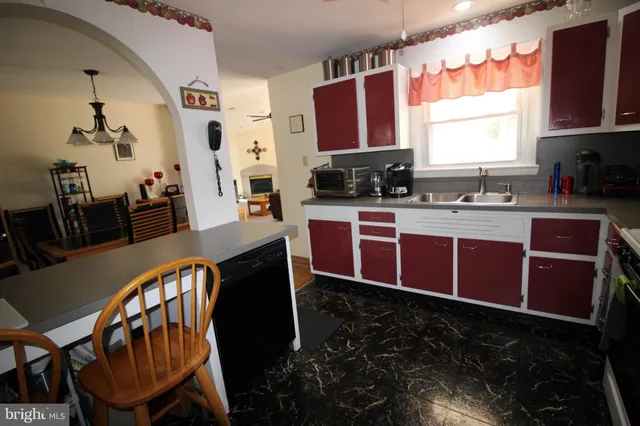 a kitchen with stainless steel appliances granite countertop a stove a sink dishwasher and cabinets