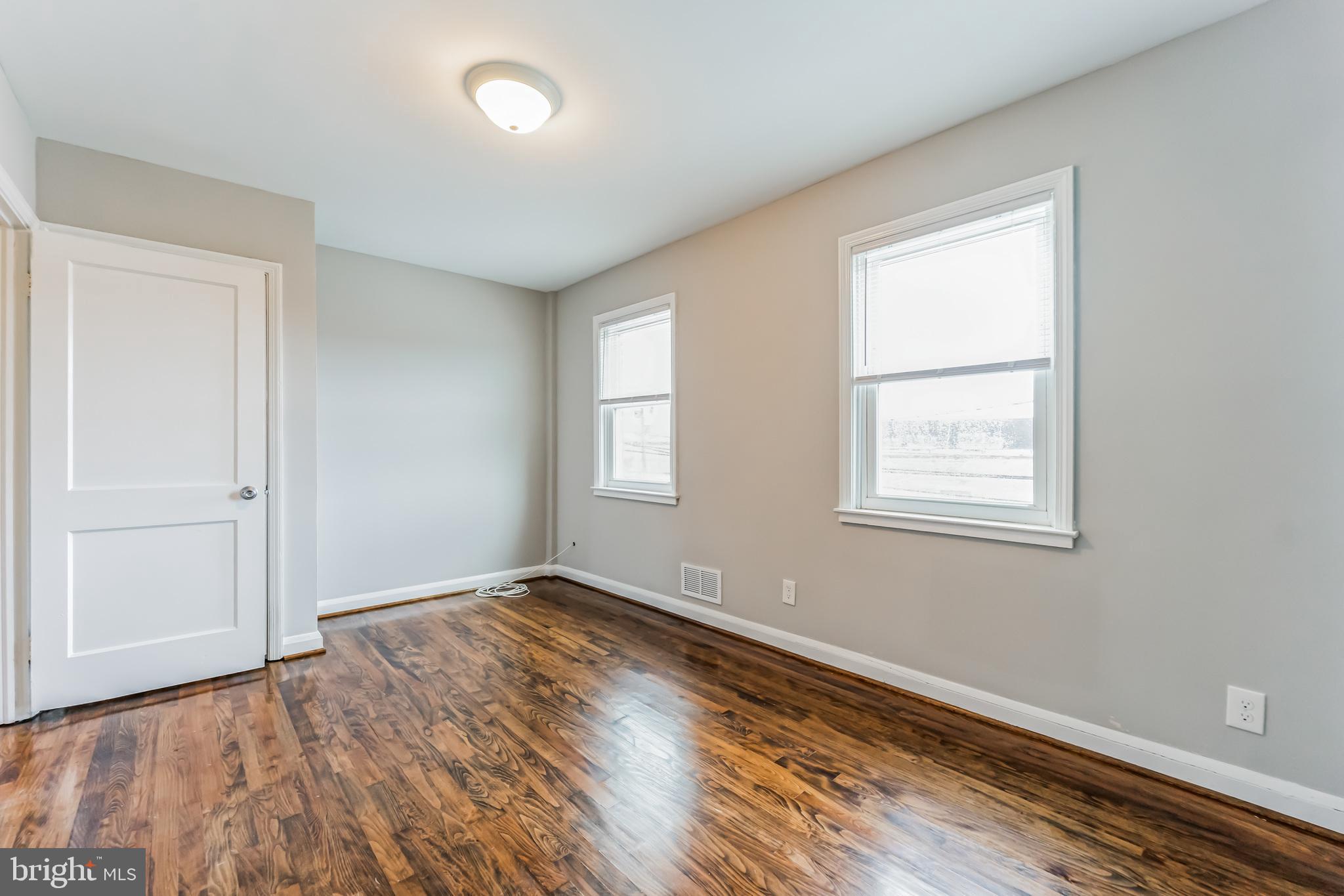 3422 Dunran Road Dundalk, MD 21222 - Photo 11 of 30 an empty room with wooden floor and windows