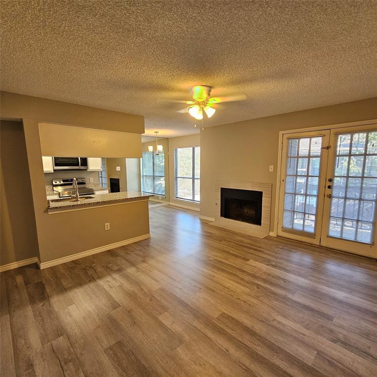 5750 Phoenix Drive, Unit 15 Dallas, TX 75231 - Photo 6 of 23 a view of an empty room with window and wooden floor