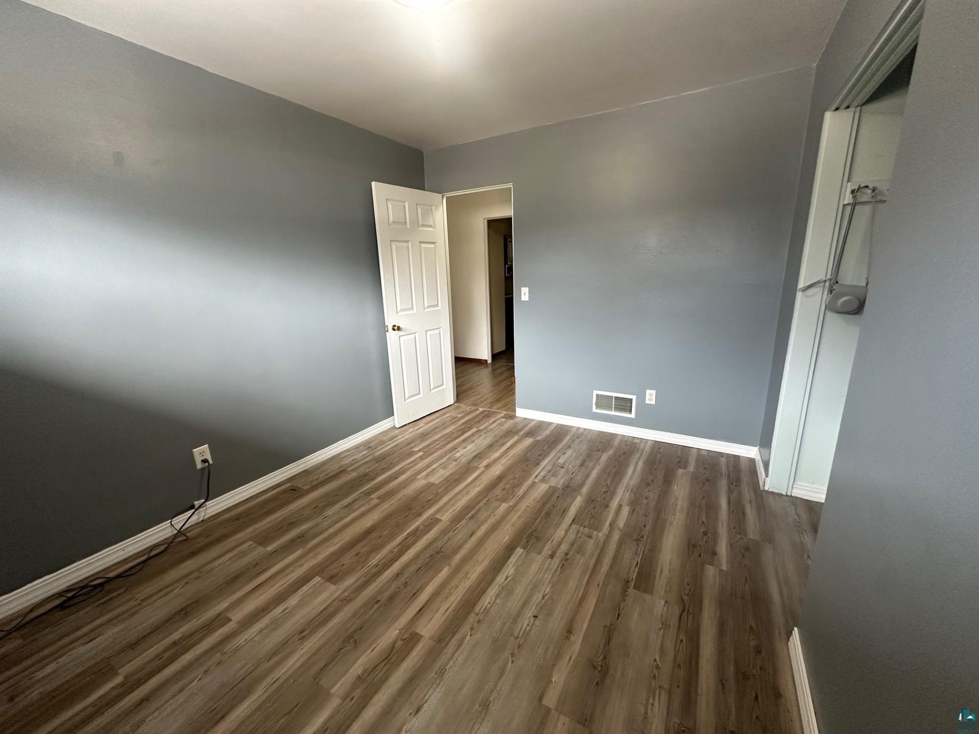 702 27th Street Cloquet, MN 55720 - Photo 11 of 25 Spare room with dark wood finished floors and baseboards