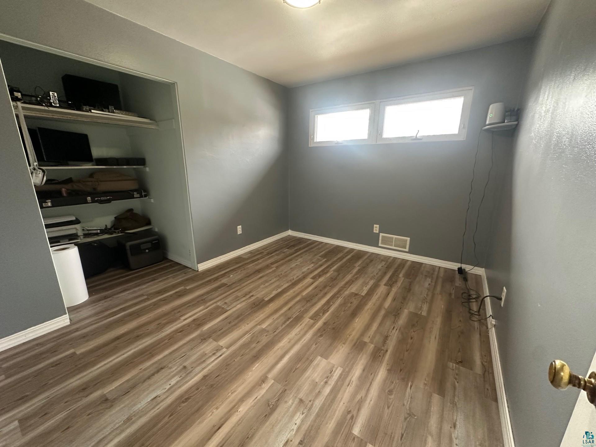702 27th Street Cloquet, MN 55720 - Photo 12 of 25 Unfurnished bedroom featuring a closet and wood finished floors