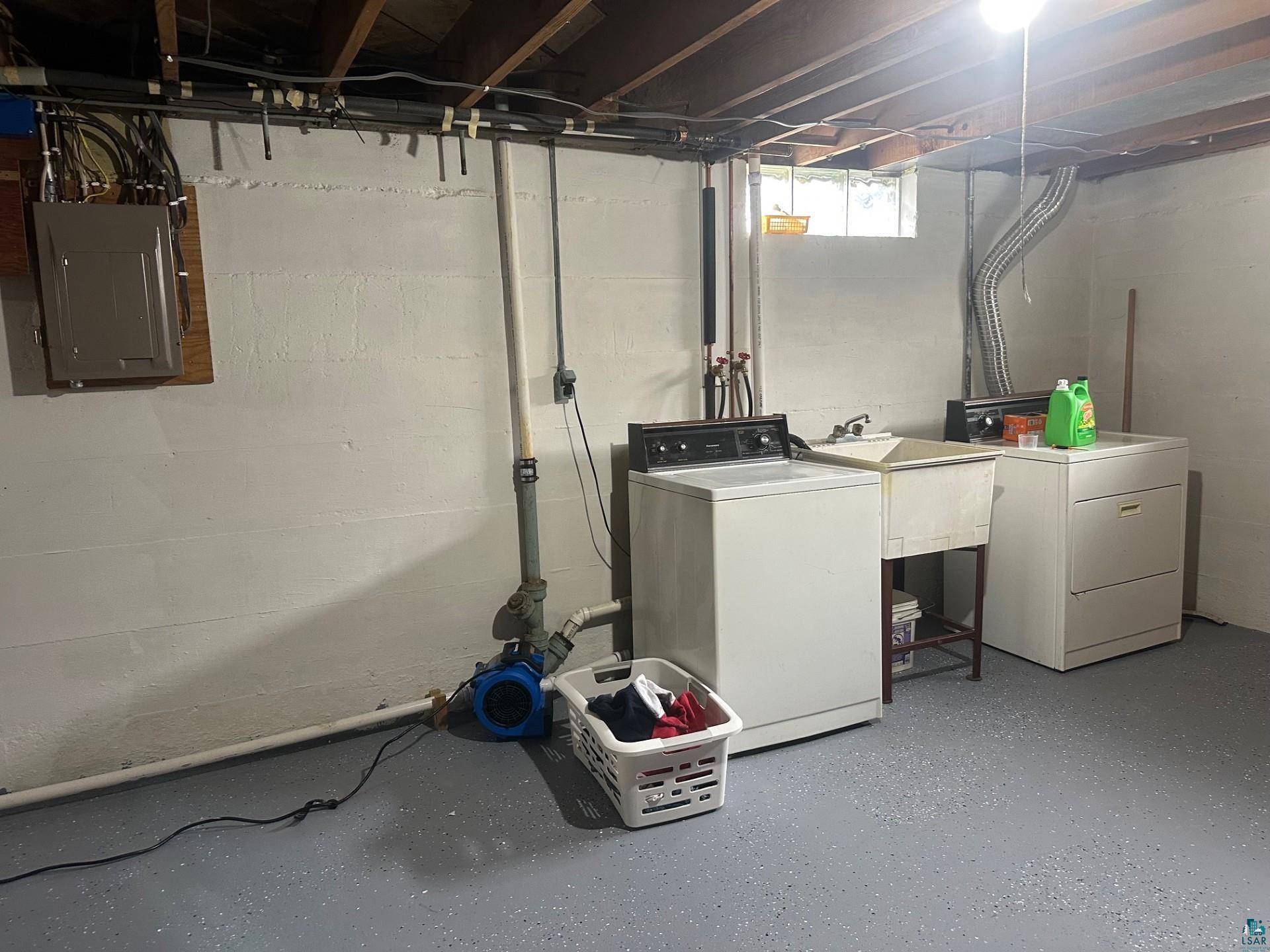 702 27th Street Cloquet, MN 55720 - Photo 14 of 25 Basement with electric panel and washing machine and clothes dryer