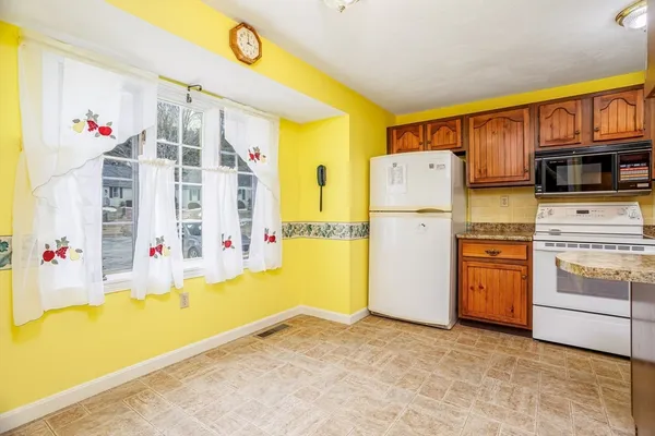 a kitchen with stainless steel appliances granite countertop a refrigerator and a stove top oven