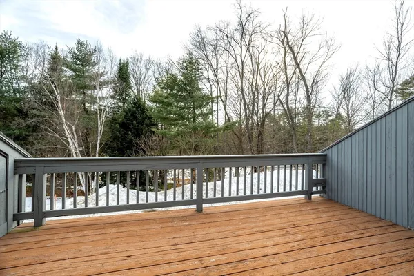 a balcony with wooden floor and fence