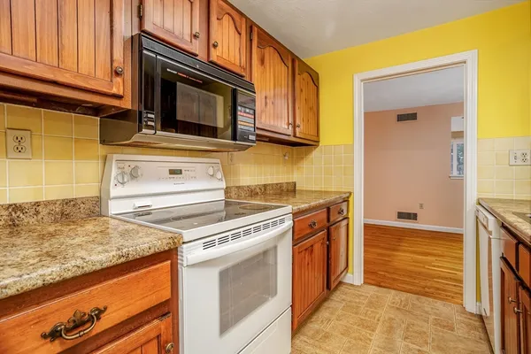 a kitchen with stainless steel appliances granite countertop a stove and a microwave
